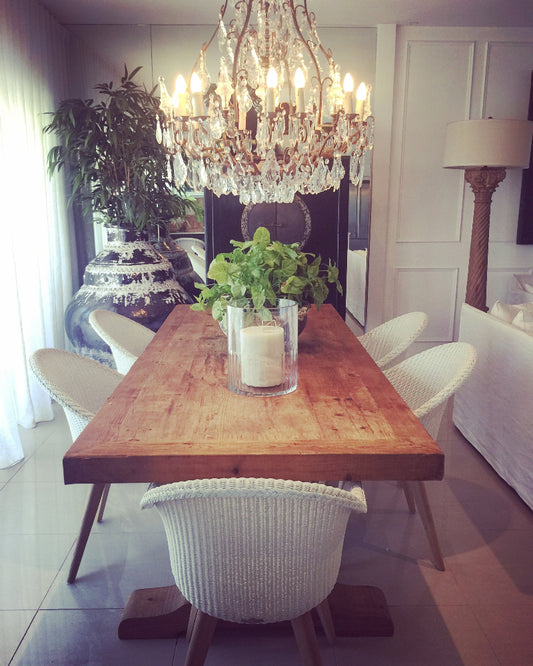 Dining room with wooden table, white chairs, and a chandelier. Bungalow Interior Designs, Gold Coast