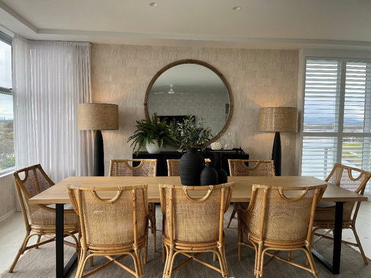 Dining room with a round mirror, table, and chairs. Bungalow Interior Design, Gold Coast
