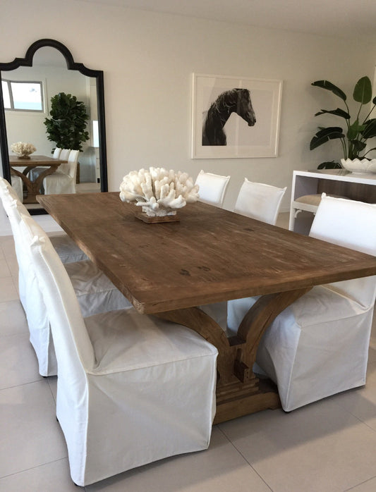 Dining room with wooden table and white chairs in a well-lit room. Bungalow Interior Design, Gold Coast