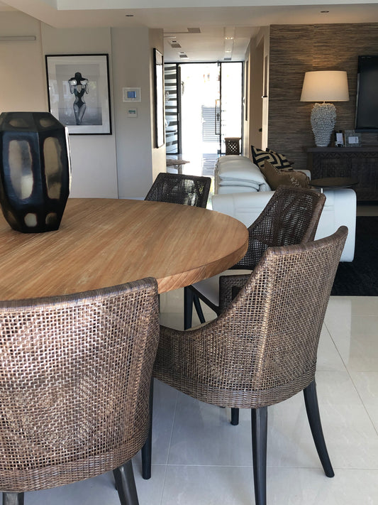 Labrador Dining area with wooden table and wicker chairs, living room in the background. Bungalow Interiors Design + Home Styling