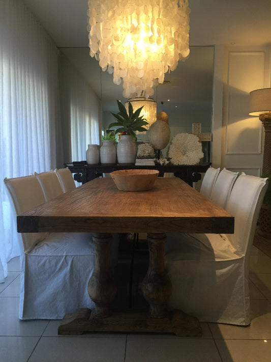 Modern interior with a wooden table, decorative pillows, and a plant. Bungalow Interiors Design, Gold Coast