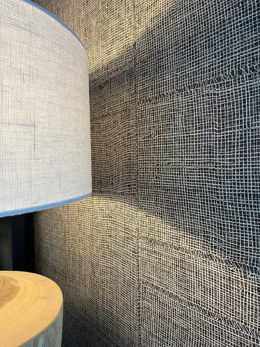 Textured wallpaper with a lamp and wooden stool in the foreground. Bungalow Home Interiors Styling, Gold Coast