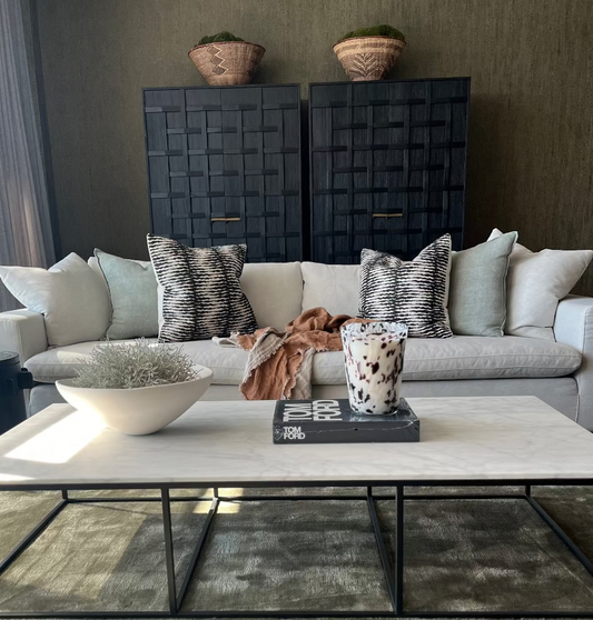 Living room with a gray sofa, coffee table, and decorative items. Bungalow Home Interiors Styling, Gold Coast