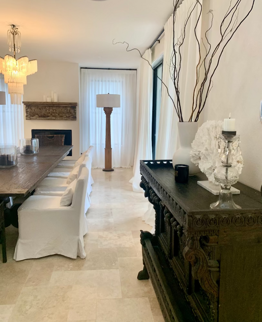 Dining room with a long table, chairs, and decorative elements. Bungalow Interiors Designer Gold Coast