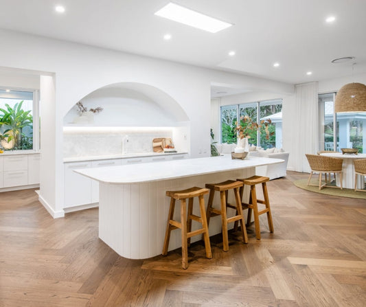 Modern kitchen with white island and wooden stools Home styling Bungalow Interiors Gold Coast