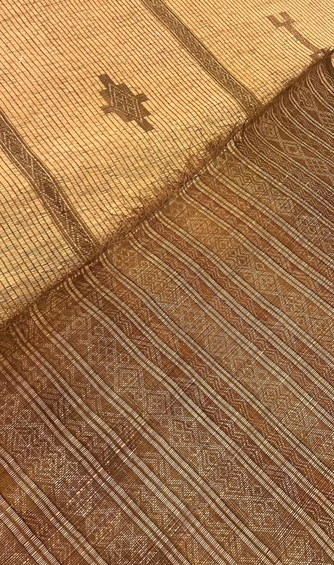 Close-up of woven fabric with geometric patterns in brown and beige tones.