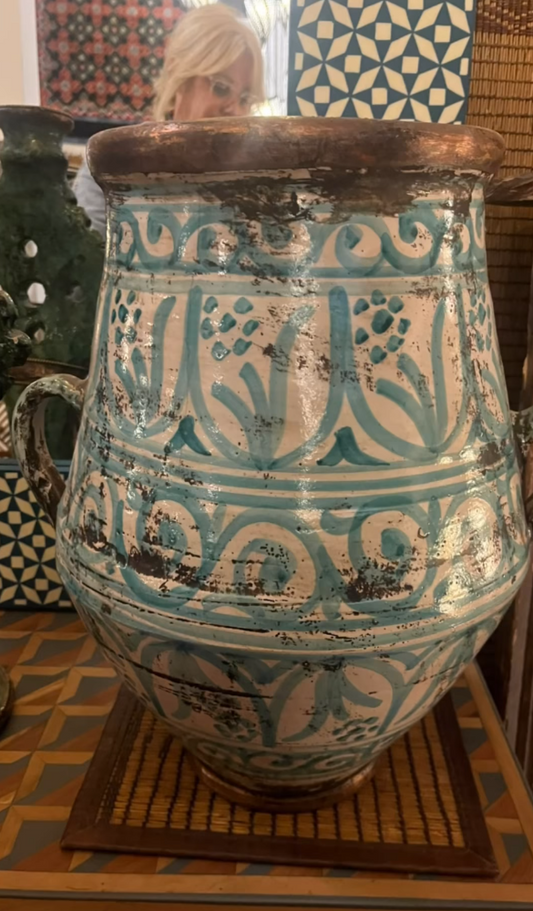 Decorative ceramic pot with intricate patterns on a patterned floor.