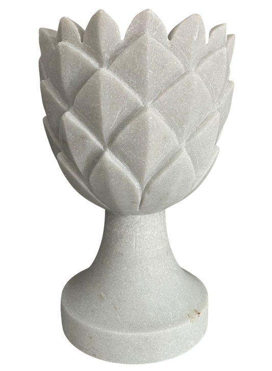 A white marble decorative pot with a carved pineapple design.
