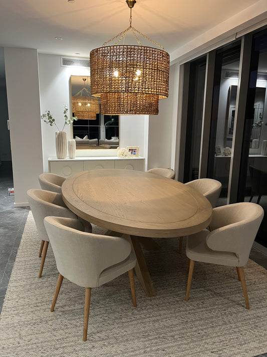 Dining room with a round wooden table and beige chairs, featuring a chandelier.  Bungalow Interior Design, Gold Coast