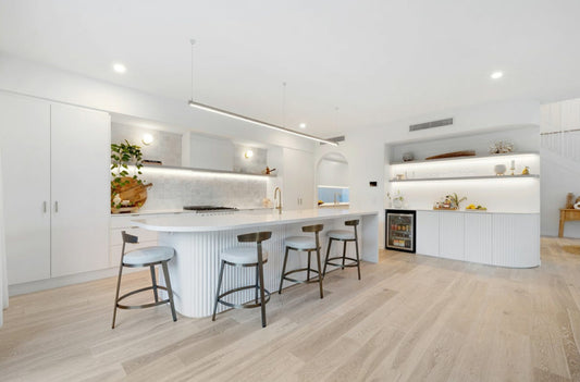 Modern kitchen with white cabinetry, island, and bar stools.  Bungalow Interiors Gold Coast, coastal interior design styling