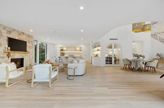 Modern living room with white furniture, wooden floor, and large windows. Bungalow Interiors Design & Home Styling, Gold Coast