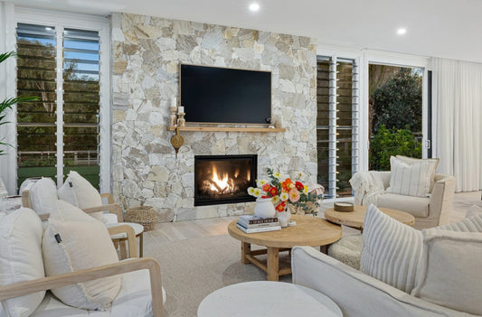 Modern living room with stone fireplace, television, and comfortable seating.  Bungalow Interiors Gold Coast, coastal interior design styling