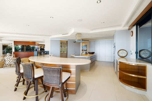 Modern kitchen with island and chairs in a well-lit room.  Bungalow Interiors Home Styling, Gold Coast